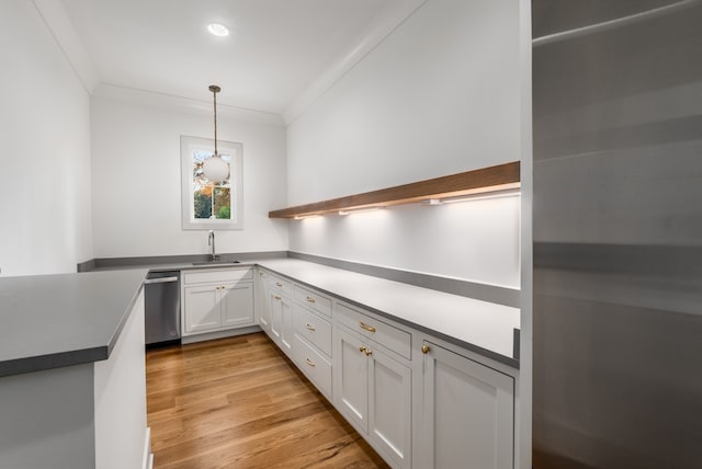 kitchen featuring sink, dishwasher, pendant lighting, light hardwood / wood-style floors, and white cabinets