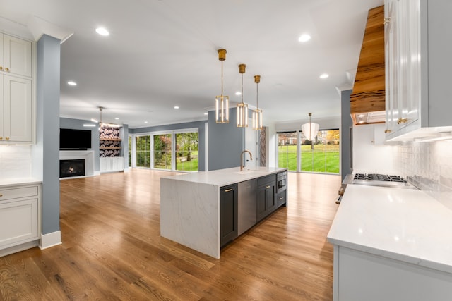 kitchen with pendant lighting, backsplash, and a large island