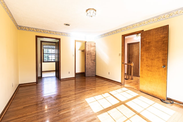 empty room with hardwood / wood-style flooring