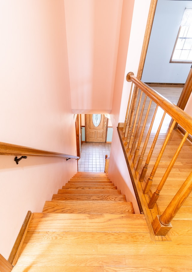 stairway featuring plenty of natural light and tile patterned flooring