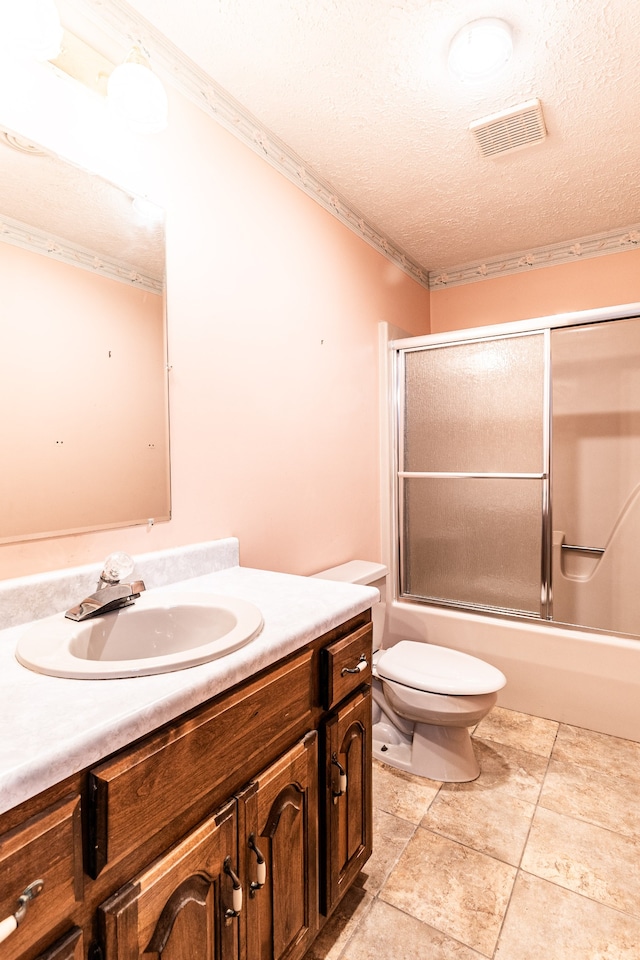 full bathroom with vanity, a textured ceiling, crown molding, enclosed tub / shower combo, and toilet