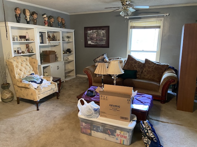 living area with a textured ceiling, carpet floors, ceiling fan, and crown molding