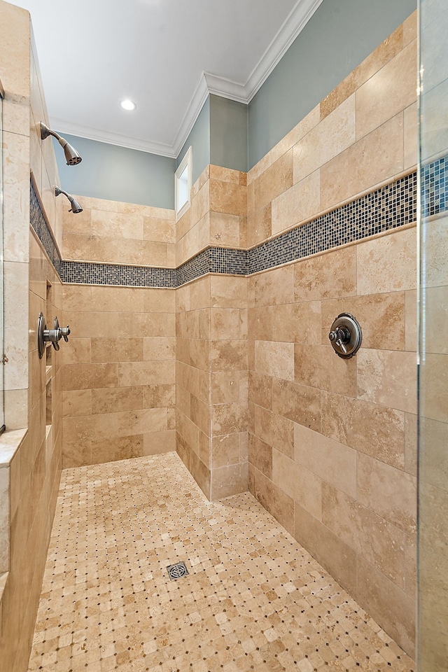 bathroom with a tile shower and ornamental molding