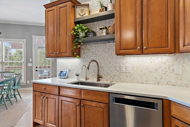 kitchen with backsplash, crown molding, sink, dishwasher, and light hardwood / wood-style floors