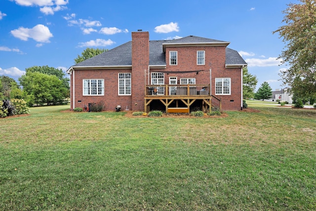 rear view of house featuring a yard and a wooden deck