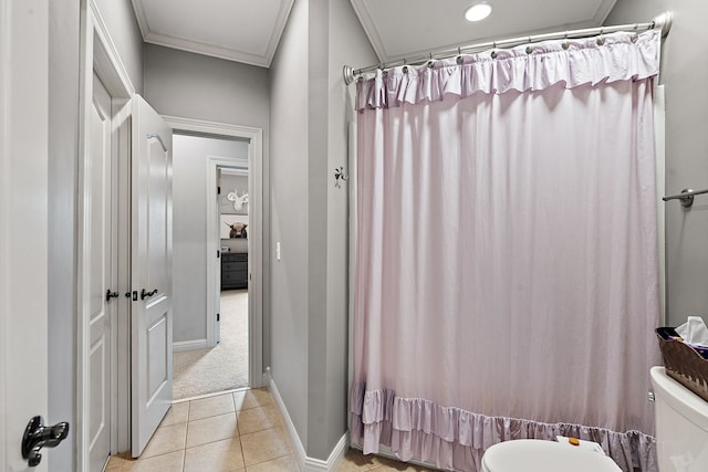 bathroom featuring shower / bath combo with shower curtain, crown molding, tile patterned flooring, and toilet