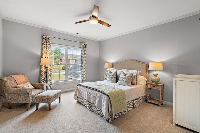 carpeted bedroom featuring ceiling fan and crown molding