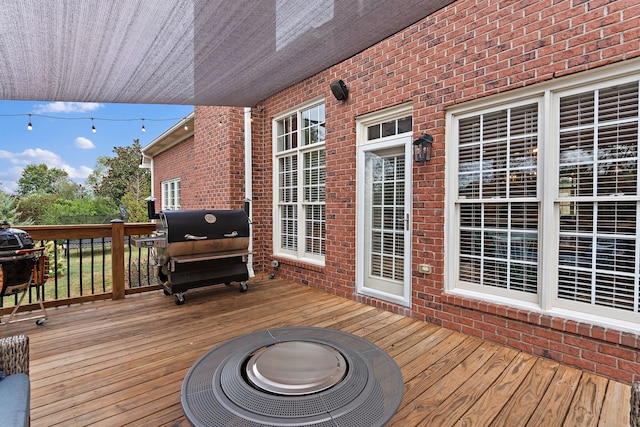 wooden terrace with a fire pit