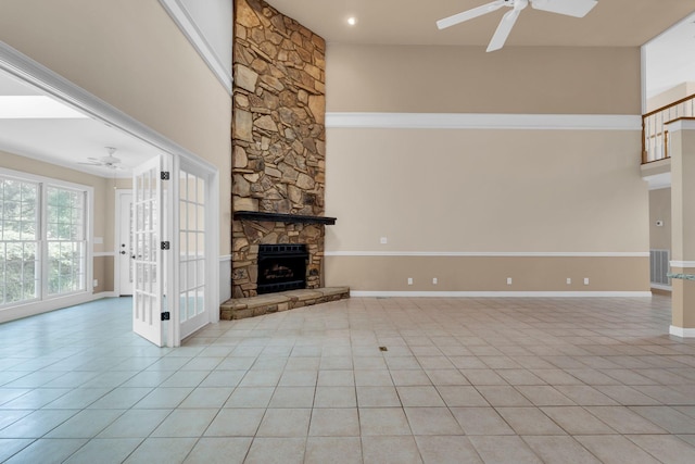 1406 Ottawa Pl, Murfreesboro, TN 37129 - unfurnished living room featuring ceiling fan, light tile patterned flooring, a towering ceiling, baseboards, and a fireplace