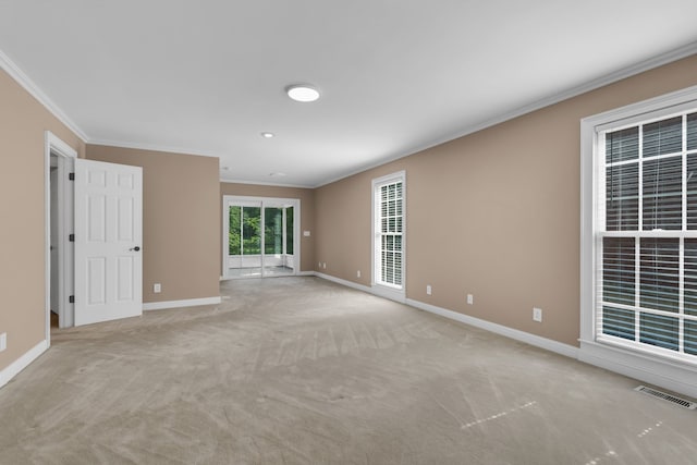 carpeted empty room featuring crown molding