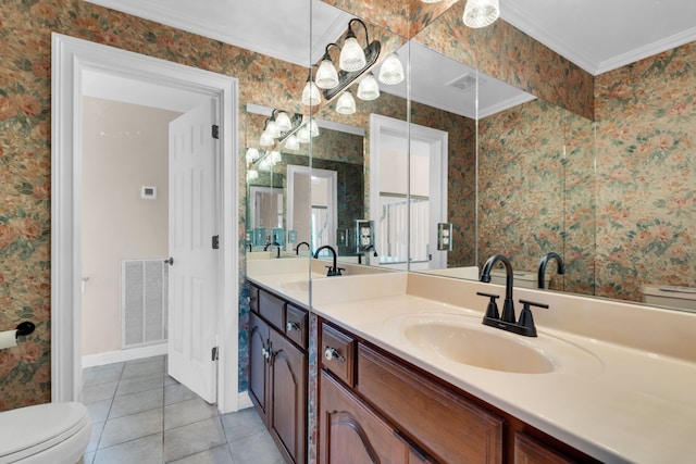 bathroom featuring tile patterned floors, toilet, vanity, and ornamental molding