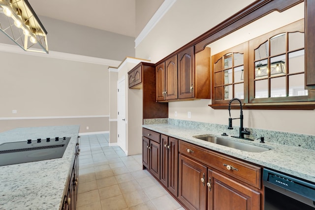 kitchen featuring black appliances, light stone countertops, and sink