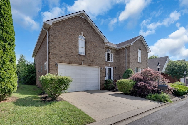 view of property featuring a garage and a front lawn