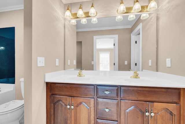 bathroom with vanity, toilet, and ornamental molding