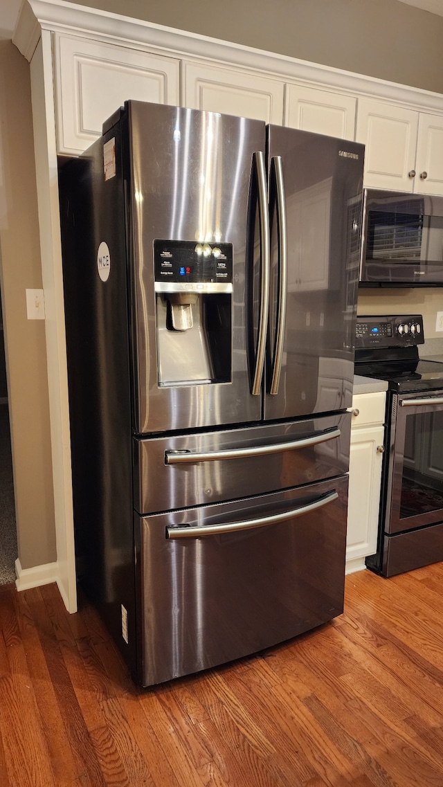 kitchen with white cabinetry, light wood-type flooring, and appliances with stainless steel finishes