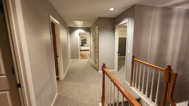 hall featuring light colored carpet