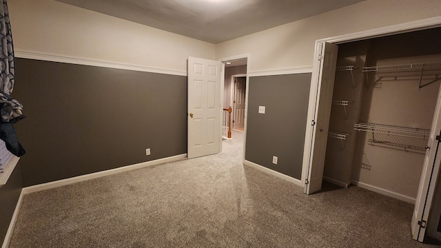 unfurnished bedroom with carpet floors and a closet