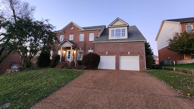 view of front of home featuring a garage and a front lawn