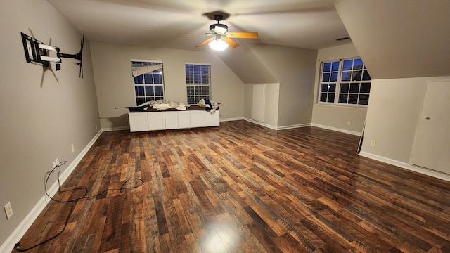 additional living space with ceiling fan and dark wood-type flooring