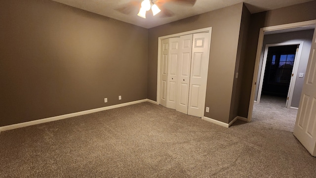 unfurnished bedroom featuring ceiling fan, a closet, and carpet