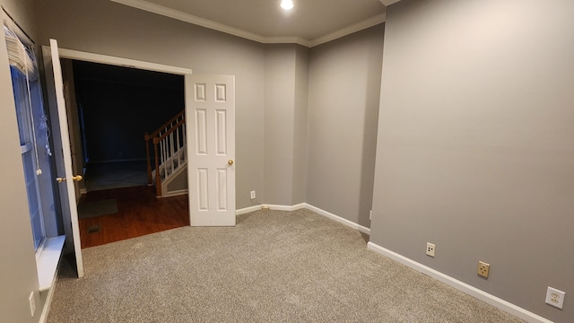 carpeted spare room featuring ornamental molding