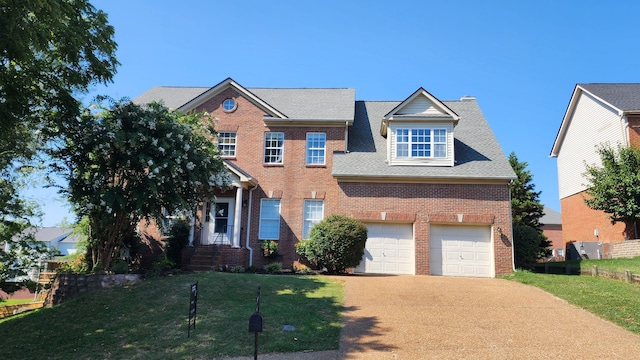 view of front facade featuring a front yard and a garage