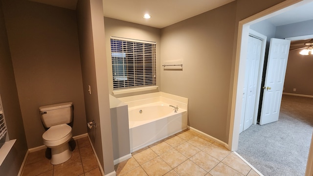 bathroom featuring a tub, ceiling fan, tile patterned flooring, and toilet