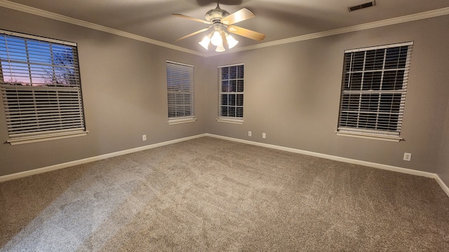 carpeted spare room featuring ceiling fan and ornamental molding