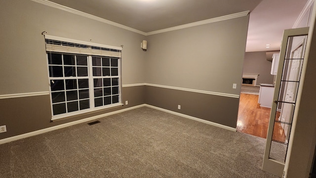 spare room with carpet and ornamental molding