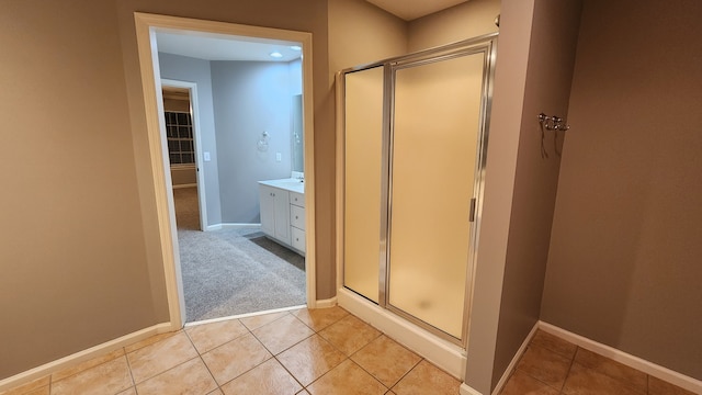 bathroom featuring tile patterned floors, vanity, and an enclosed shower