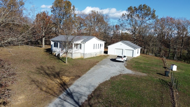 view of front of property with an outbuilding, a front lawn, and a garage