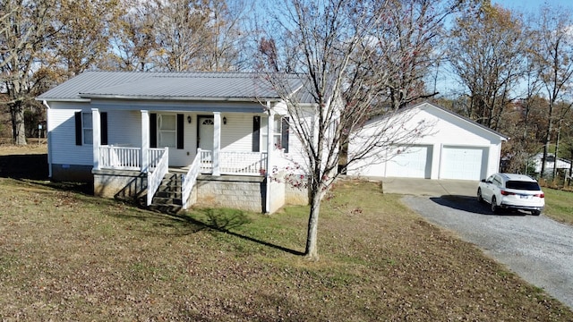 view of front facade with a porch, a garage, an outdoor structure, and a front lawn