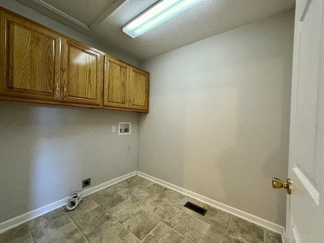 washroom with hookup for an electric dryer, cabinets, and hookup for a washing machine