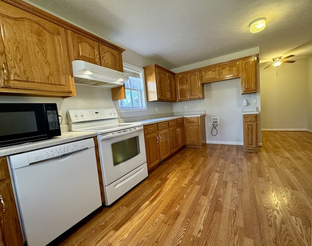 kitchen with a textured ceiling, ceiling fan, light hardwood / wood-style flooring, and white appliances