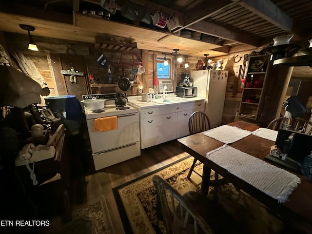 kitchen with dark hardwood / wood-style floors, sink, white appliances, and hanging light fixtures