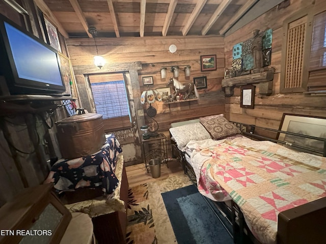 bedroom with wood walls and light hardwood / wood-style flooring