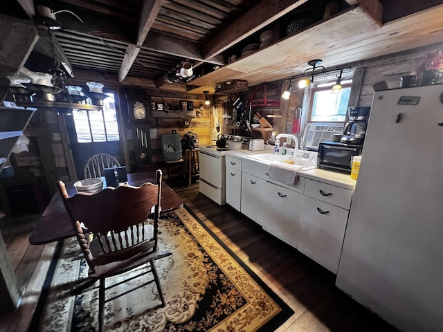 kitchen with sink, white cabinetry, decorative light fixtures, dark hardwood / wood-style floors, and white appliances