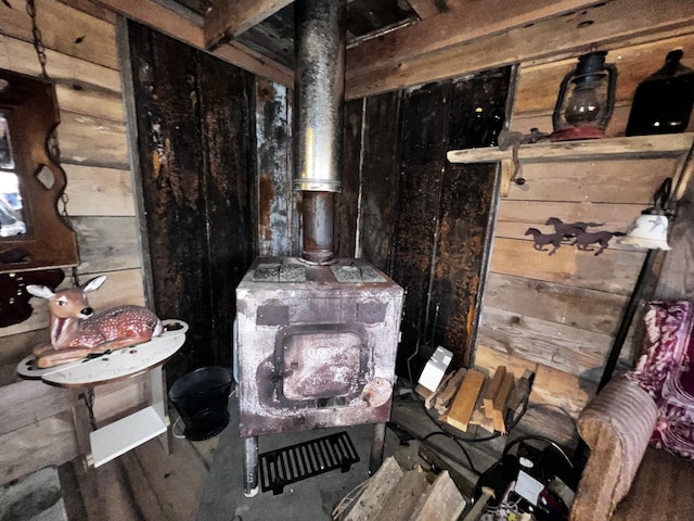 interior details featuring a wood stove and wooden walls