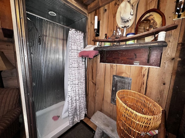 bathroom with wooden walls and curtained shower