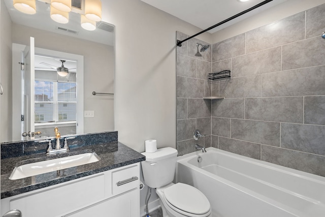 full bathroom featuring vanity, toilet, tiled shower / bath, and ceiling fan