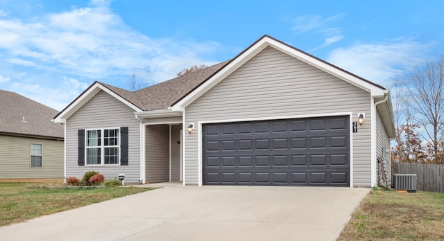 ranch-style home with a garage, a front yard, and central AC