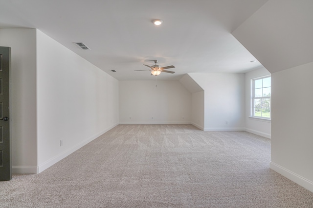 additional living space featuring light colored carpet and ceiling fan