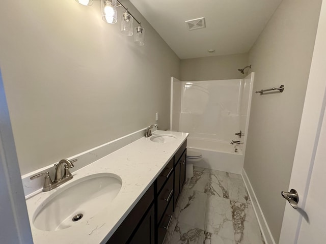 bathroom featuring marble finish floor, visible vents, a sink, and baseboards