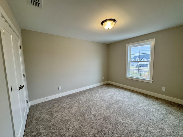 unfurnished bedroom with baseboards, visible vents, and carpet flooring