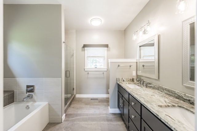 bathroom with vanity and separate shower and tub