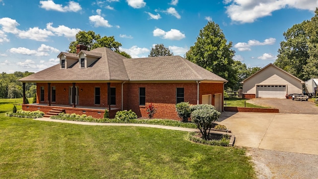 view of front facade featuring covered porch, a garage, and a front lawn