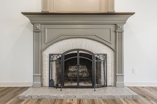 interior details featuring wood-type flooring and a fireplace