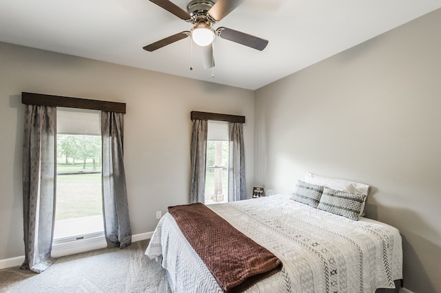 carpeted bedroom featuring ceiling fan and a baseboard radiator