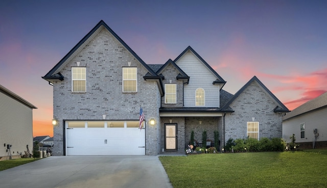 view of front of house with a yard and a garage