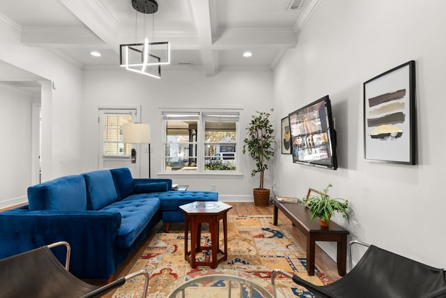 living room featuring beamed ceiling, hardwood / wood-style flooring, ornamental molding, and a notable chandelier